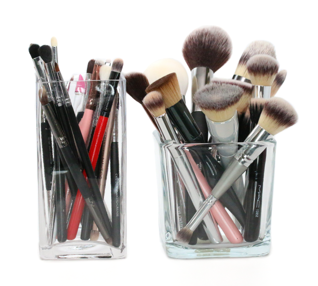 makeup brushes in glass vases