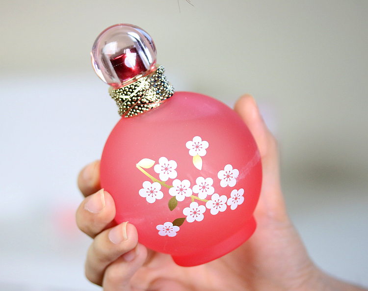 pink perfume bottle with white flowers