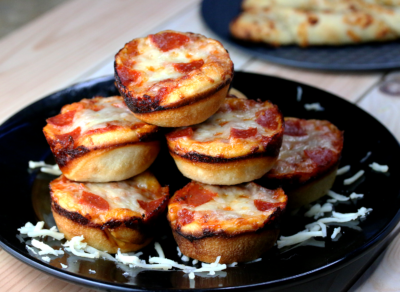 stack of mini pepperoni pizzas on a plate