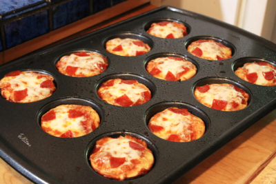 mini pizzas in a muffin pan