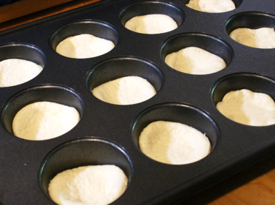 pizza dough in a muffin pan